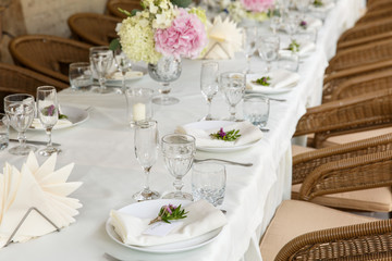 Decoration and table appointments in restaurant or cafe for lunch, dinner or celebrating marriage, wedding and other event and party. Beautiful table setting