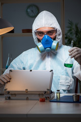 Fototapeta na wymiar Forensic investigator working in lab looking for evidence