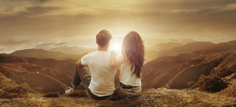 Young, relaxed couple watching a sunset