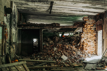 Fototapeta na wymiar Interior of destructed building by earthquake or war, pile of bricks and rubbish