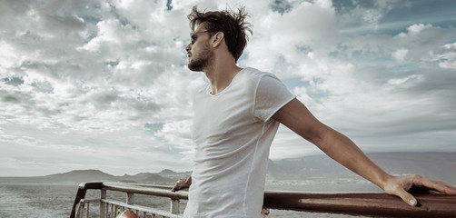 Handsome man relaxing on the ship