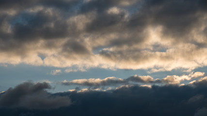 Fototapeta na wymiar Background with dramatic thunderclouds on blue sky