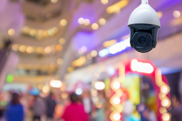 Modern CCTV security camera in shopping mall , Background blurred