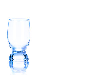 An empty glass of water toned in blue color.
