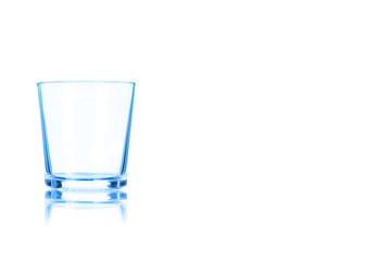 Empty glass of whiskey toned in blue color.