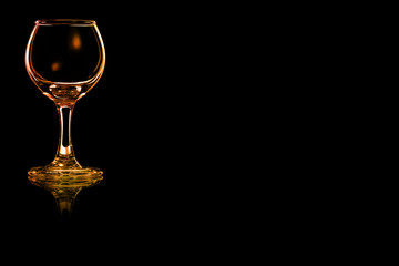 Empty glass of liqueur or cocktail sour with fire reflection.