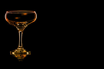 En empty champagne glass with fire reflection.