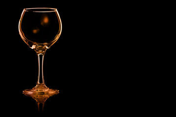 An empty glass of red wine with fire reflection.