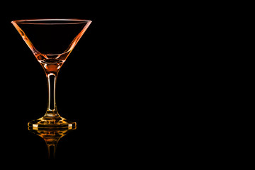 Empty Martini glass with fire reflection.
