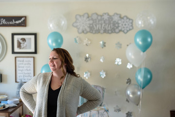 woman standing in home getting house ready for first birthday party