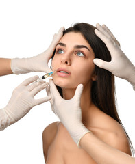 Plastic surgery beauty concept young brunette woman face and  doctor hand in glove with syringe