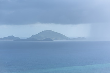 Les Saintes islands in Guadeloupe, panorama between sea and sky, view from Basse Terre, rainy in background
