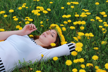 woman on ground dandelion meadow