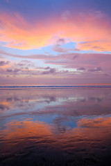 Empty Kuta beach with amazing colors sunset and sky reflection, Bali, Indonesia