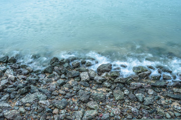high angle view of the Sea waves splash on stones.