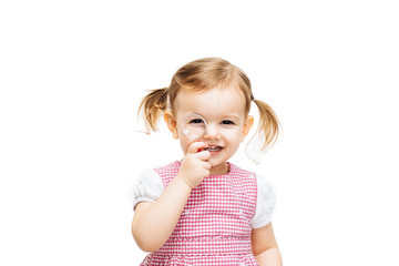 Toddler girl with magnifying glass