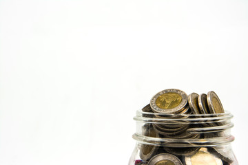 coin stacks in glass with tree on white background