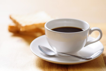 Breakfast with coffee and toast on wooden table