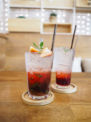 glass of strawberry juice with soda on wooden table