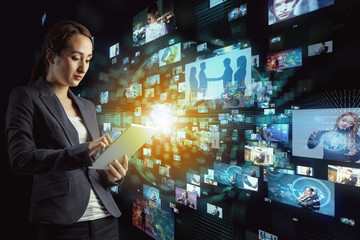 Young woman watching many pictures with tablet PC.