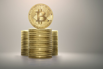 Golden bitcoin standing on stack of money coins