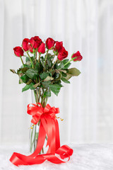 Red rose with red ribbon with copy space.