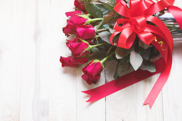 Red rose on wood background with copy space.