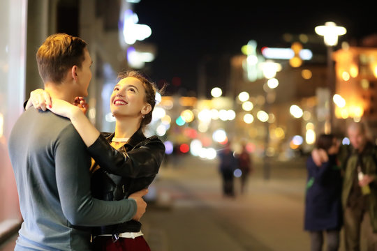 Beautiful couple on a date in a night city