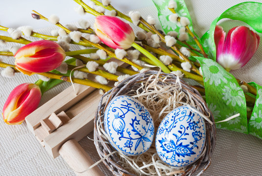 Czech traditional easter decoration, my own homemade  painted eggs in the nest with flowers and rattlesnake music instrument