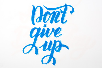 Don't give up - inspirational quote brush lettering in blue on white background