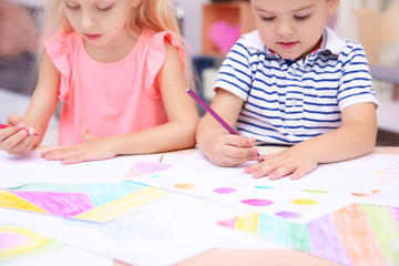 Cute little children drawing at home