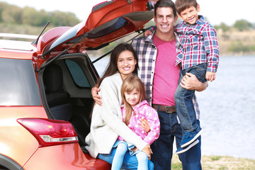 Happy family near car outdoors