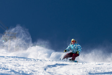 Fototapeta na wymiar Fast snowboarder at ski slope