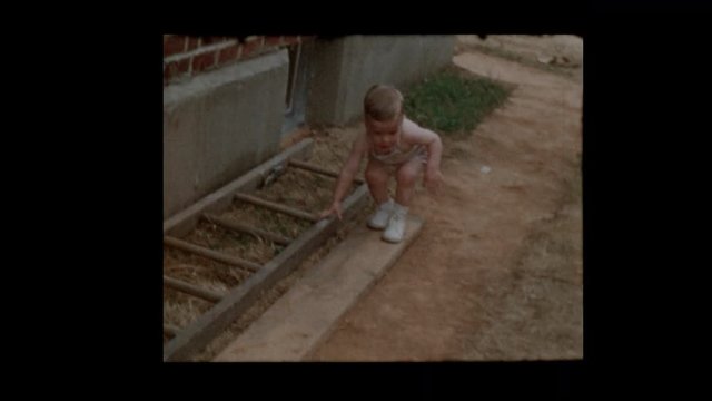 1953 Uneasy toddler boy stumbles and falls