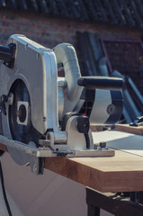 Fototapeta premium Close up electric saw to sawing wood board, solf focus.