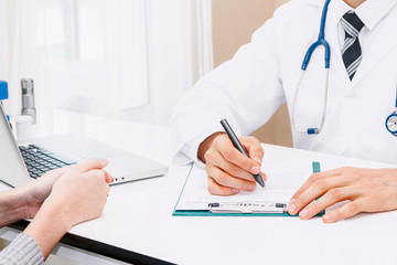 Fototapeta premium Doctor medical check up information with woman patient on doctors table in hospital.healthcare and medicine