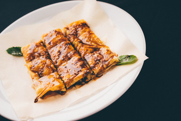 three fresh rolled stuffed crepes on plate, filtered imageg