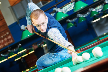 man playing billiard in club