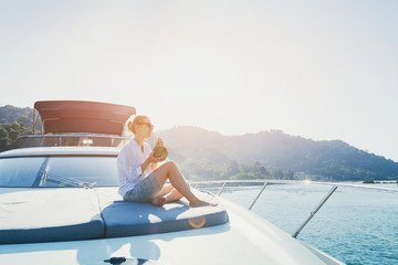 woman enjoying sunset trip onboard of luxuious yacht, luxury sea cruise travel on the boat