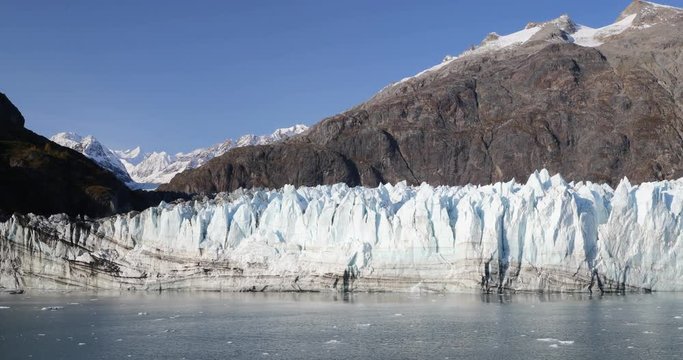 Alaska Glacier Bay nature landscape view from cruise ship holiday travel. Global warming and climate change concept with melting glacier with Margerie Glacier and Mount Fairweather Range mountains.