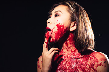 girl in blood makeup on sark background