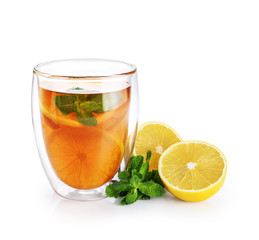 Hot tea with mint and lemon in a glass with double walls isolated on white background.