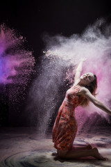 Obraz na płótnie Canvas Young girl during photoshoot with flour