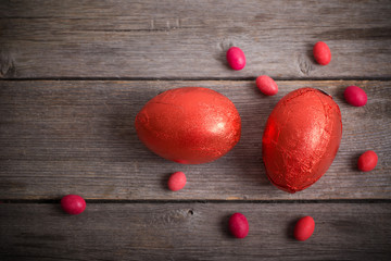 red Easter eggs on dark wooden background