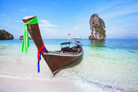 beautiful beach in Thailand, paradise landscape with turquoise blue clear water and wooden long-tail boat, summer holiday travel