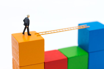 Businessmen use stepping stairs from begin wood to the next wood. Image use for get better position of work, business concept.