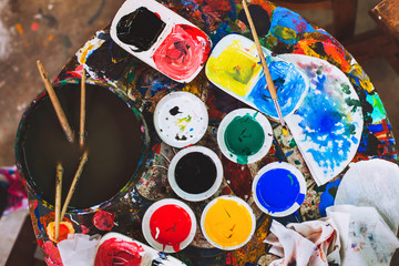 hobby and creativity concept, artist painter workplace, craftsmanship, many different colors and brushes