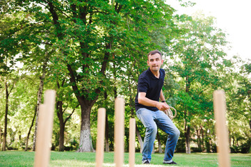 Outdoor games - guy playing ring toss in a park.
