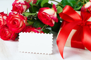 Blank card and present and bouquet red roses.