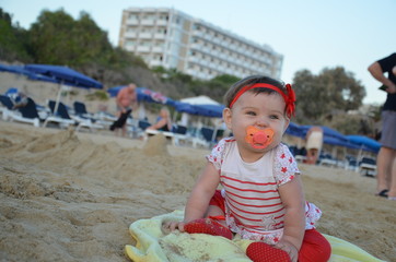 cute little girl play with seashells on beach